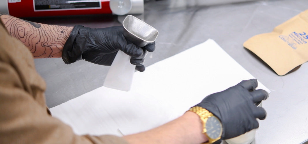 Rosin Bags Being Filled Over Parchment Paper