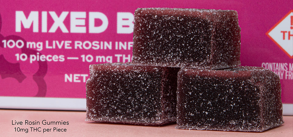 Three Leiffa Mixed Berry Live Rosin Gummies in front of their pink packaging