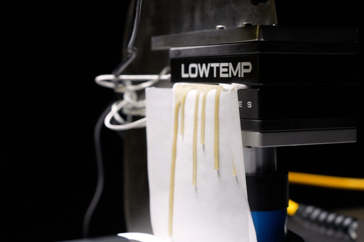 Rosin dripping off lowtemp industries rosin press parchment paper in a v4 rosin press