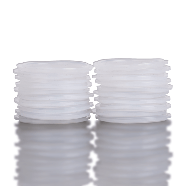 Two stacks of white silicone washers on a reflective surface with a white background