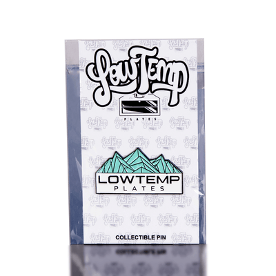Packaged collectible pin with 'Lowtemp Plates' branding on a white background