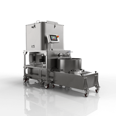 Stainless steel industrial machine on a reflective black surface with a dark background