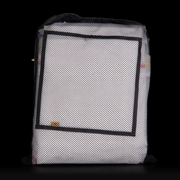 White mesh bag with black border on a black background
