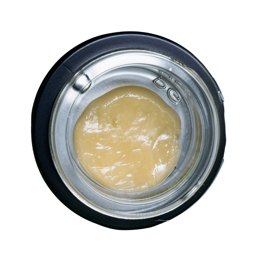 Close-up of a cosmetic container with beige cream inside on a white background