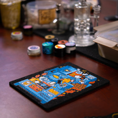 Colorful dab rig moodmat with cartoon design on a wooden surface