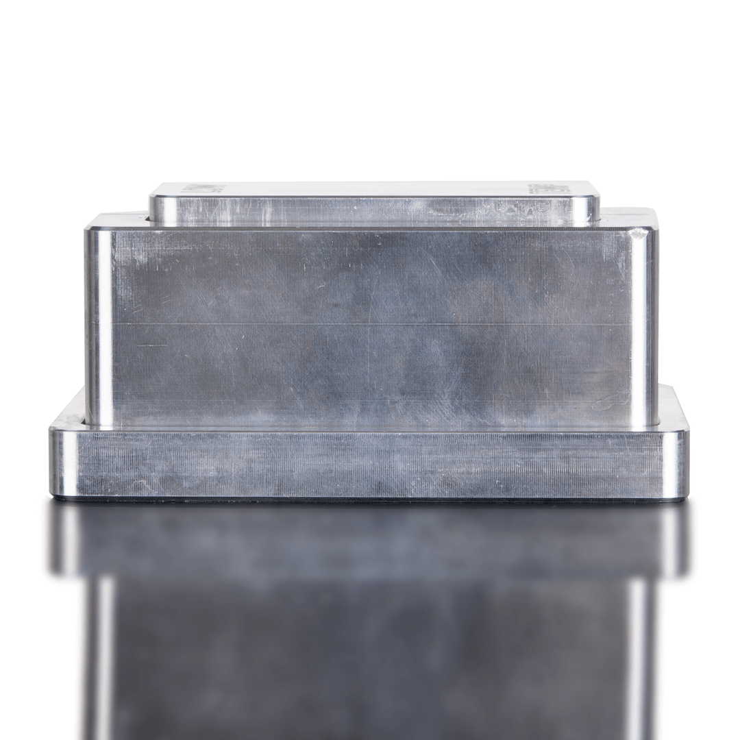 Metallic rectangular object with a reflective surface on a white background