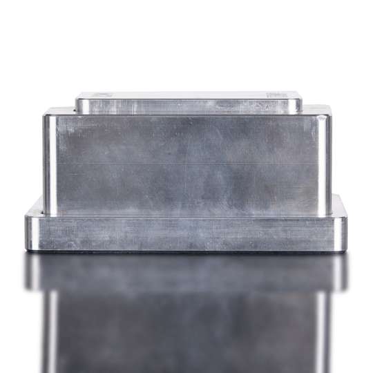 Metallic rectangular object with a reflective surface on a white background